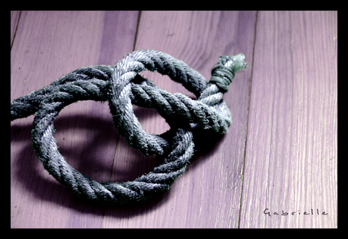 Une corde de chanvre enlace sur elle-mme sur le plancher d'une chambre